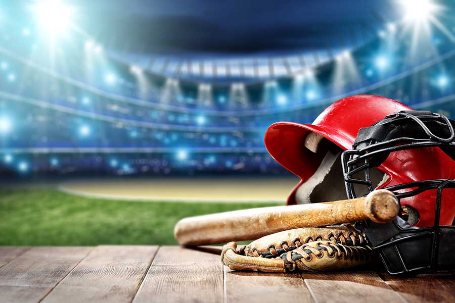 Blog - Closeup of Baseball Bat, Ball, And Glove in a Well Lit Stadium Image Graphic
