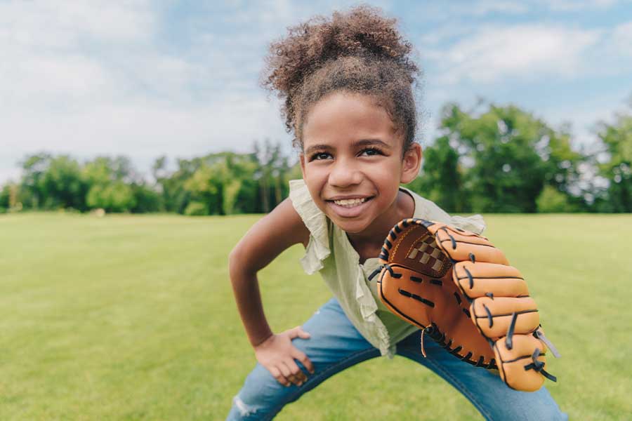 Contact - Young Girl Holding Baseball Glove and Playing Baseball with Her Family in a Park